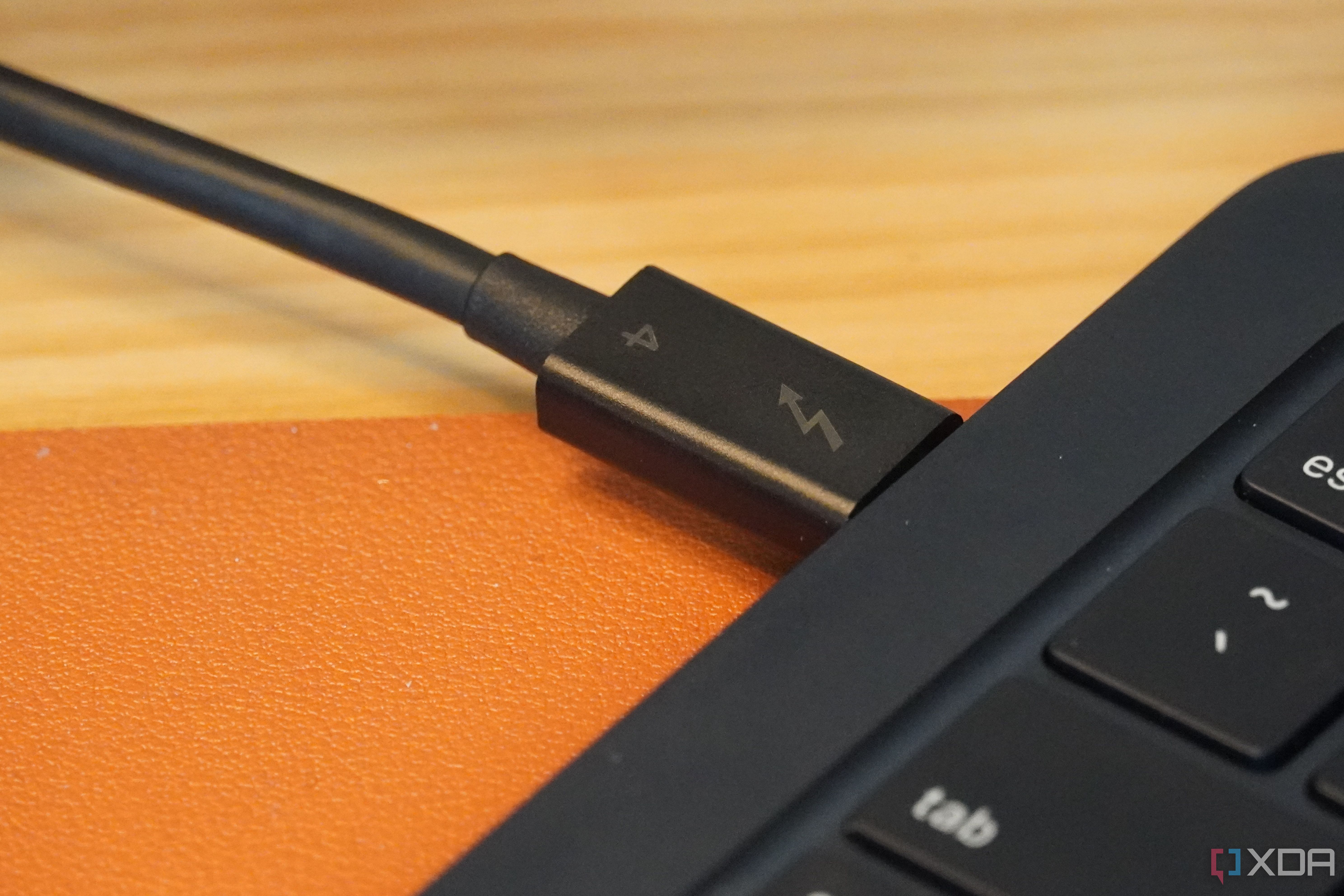 A MacBook with a Thunderbolt 4 cable connected.