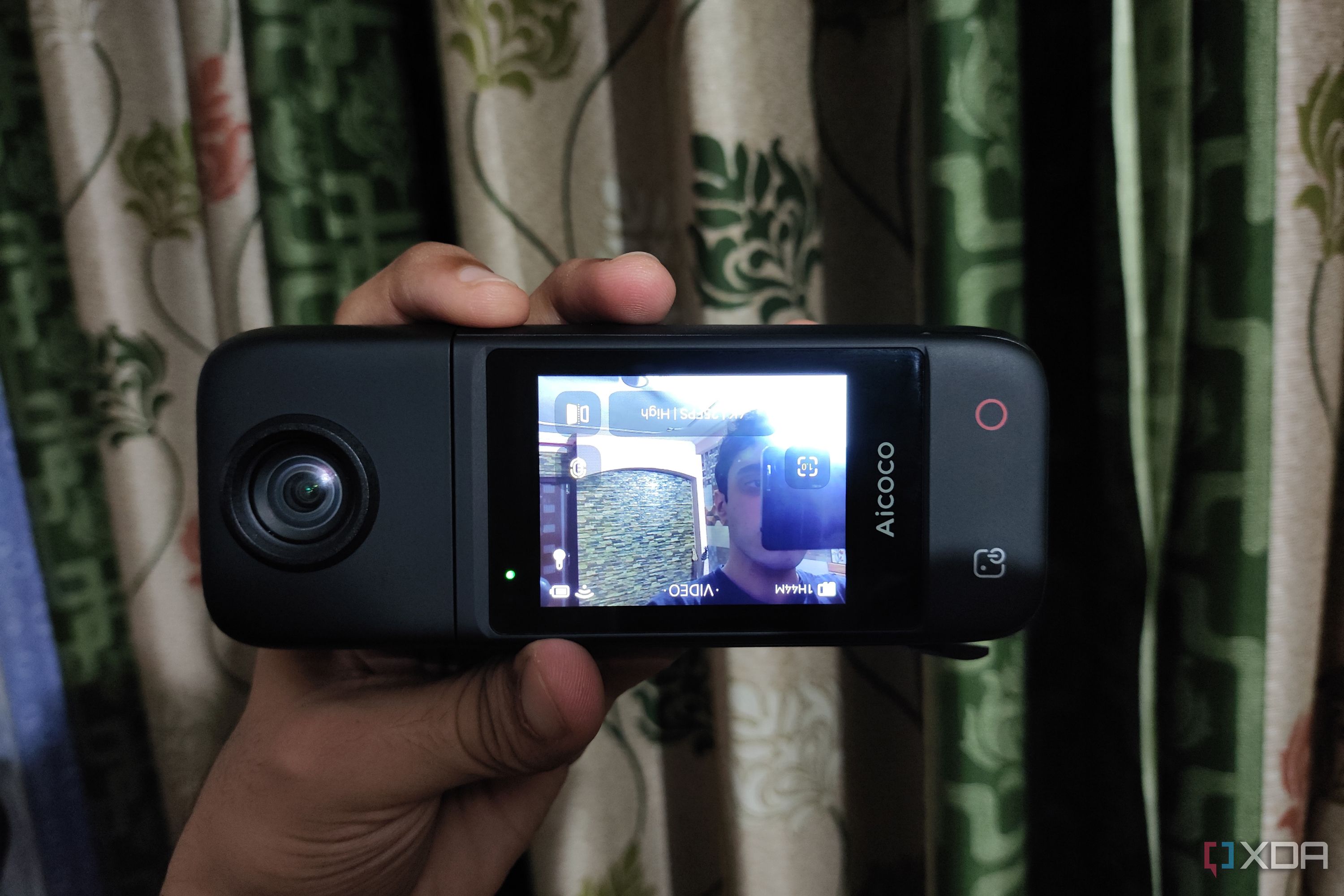 A person holding an Aicoco onAir camera