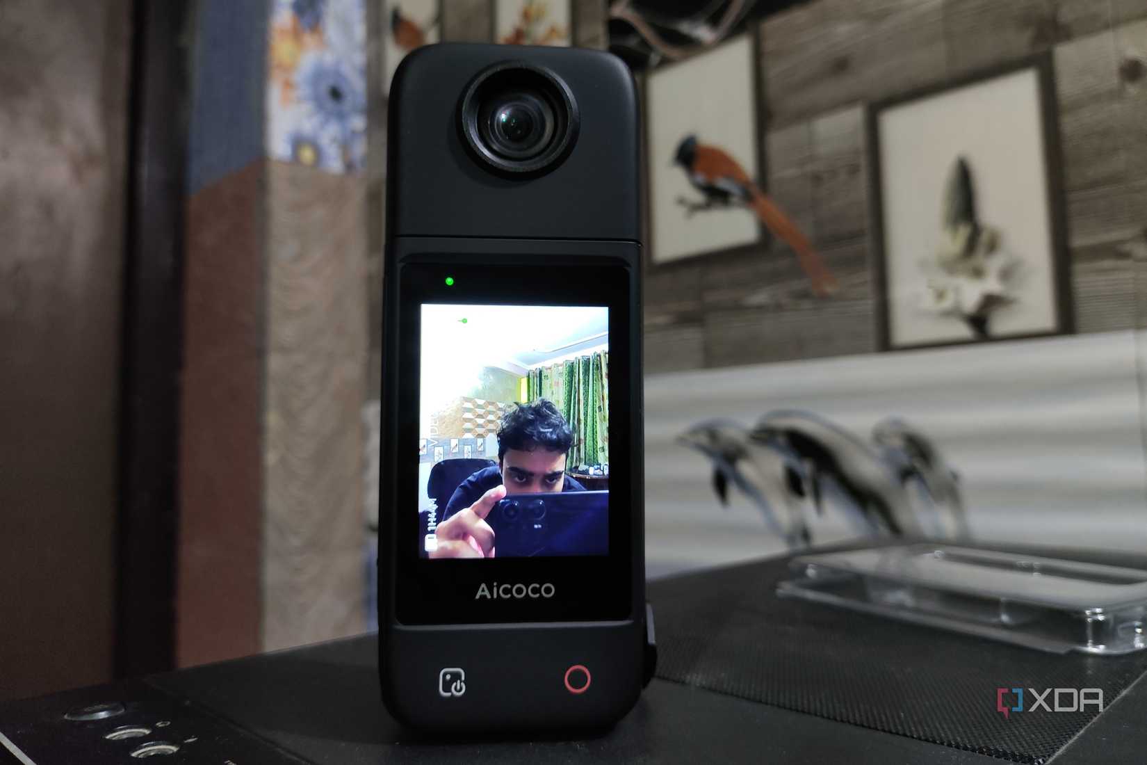 A person taking a photo of an Aicoco onAir camera