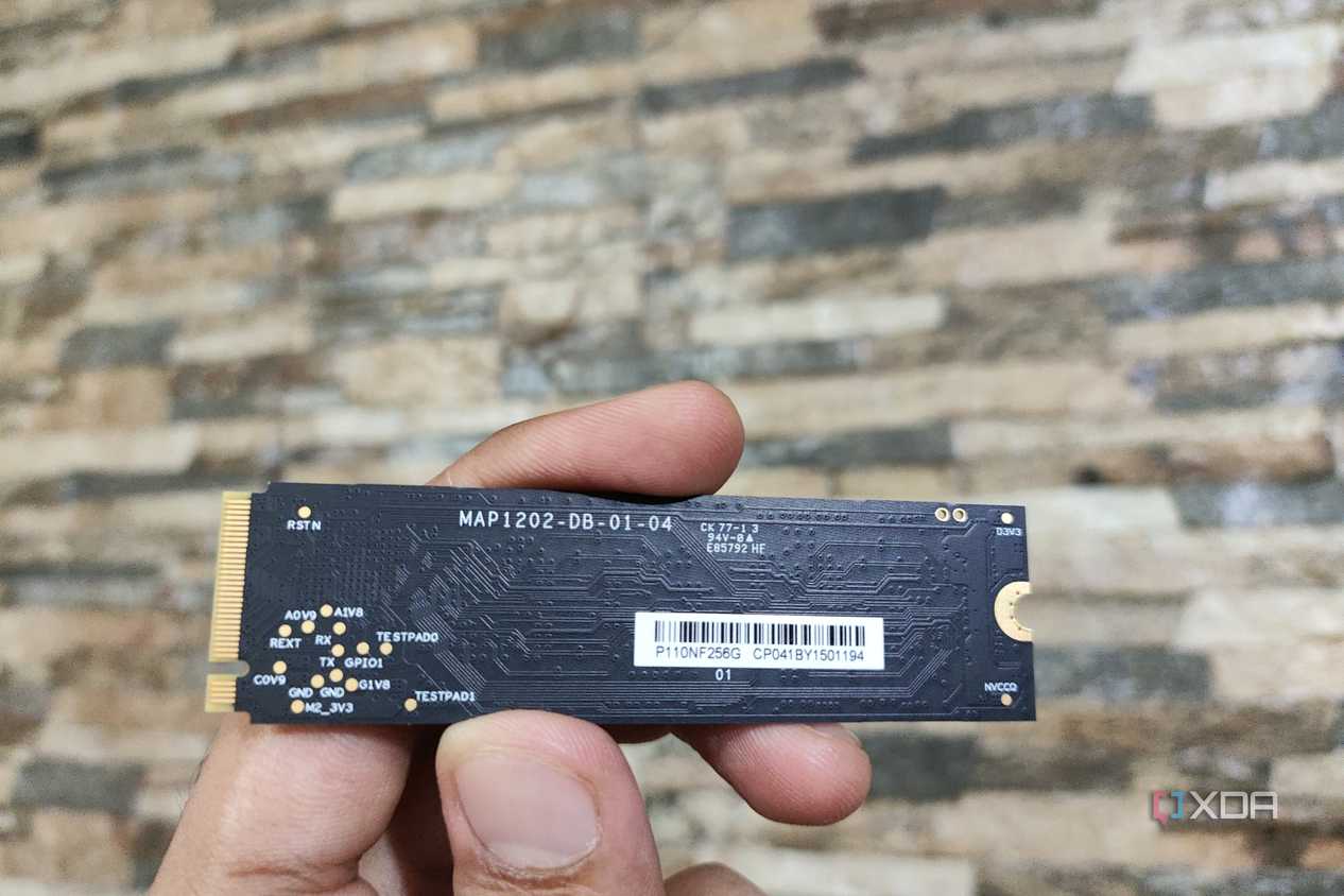 A person holding the SSD included with the Aiffro K100 NAS