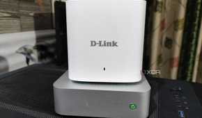 A D-Link mesh router placed on top of an Aiffro K100 NAS