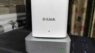 A D-Link mesh router placed on top of an Aiffro K100 NAS