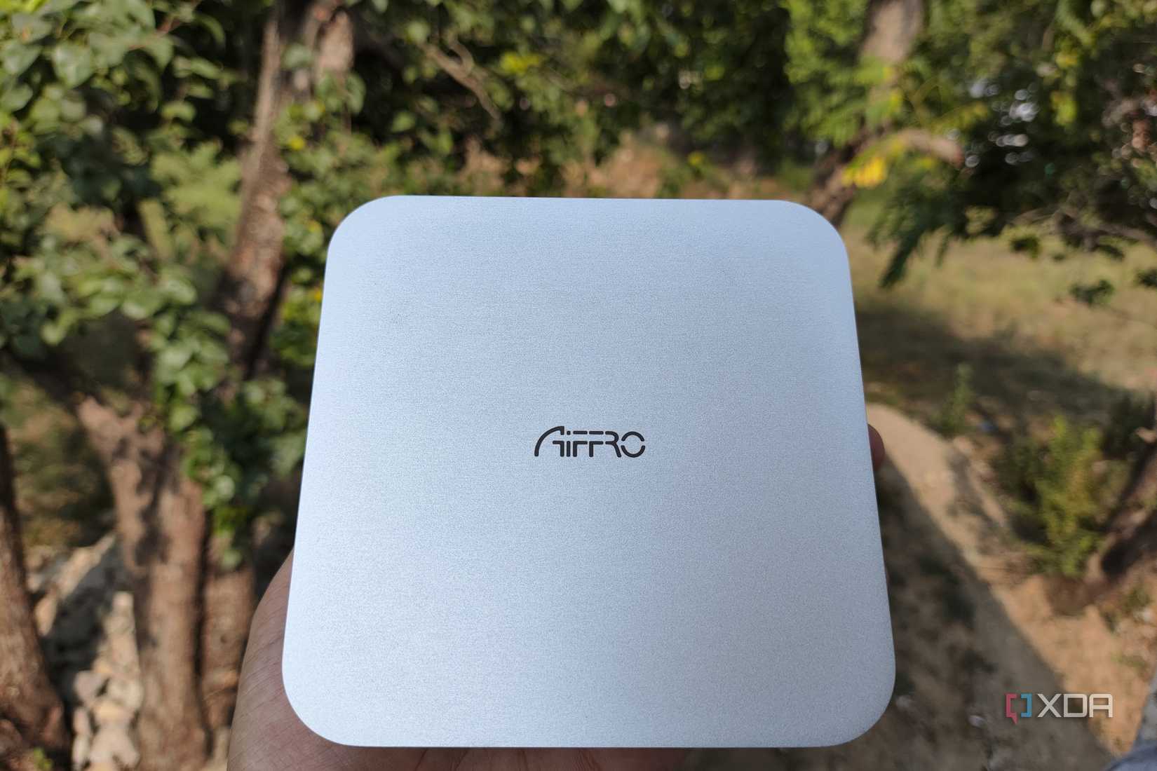 A person holding an Aiffro K100 NAS