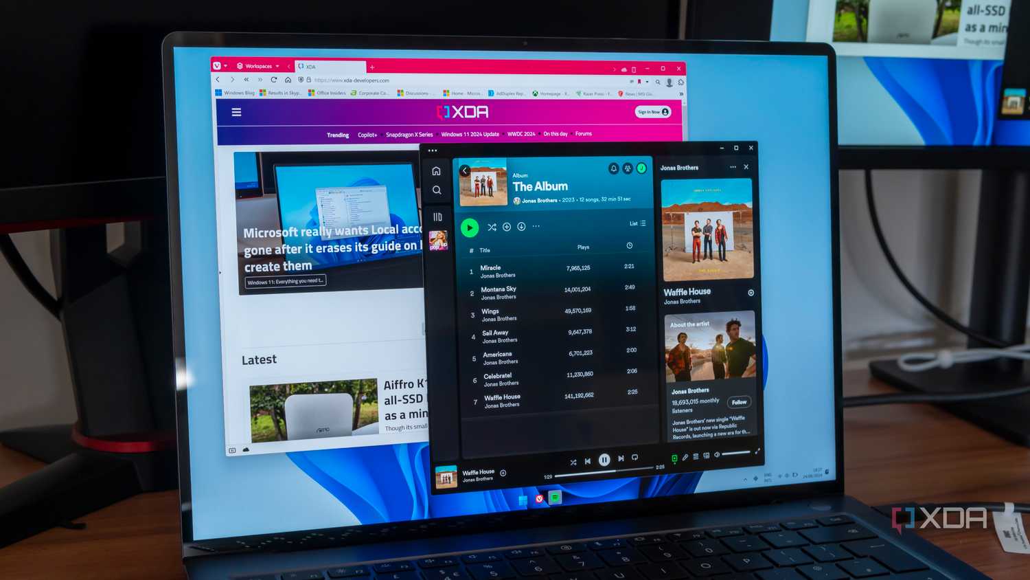A laptop running Spotify and Vivaldi