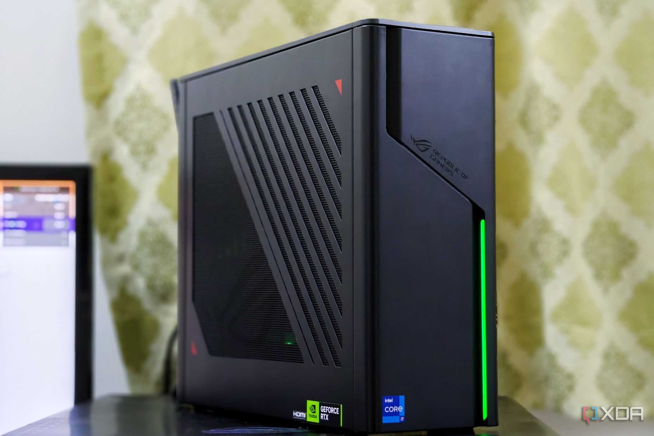 An image showing the ASUS ROG G22CH SFF PC kept on a desk next to a monitor.
