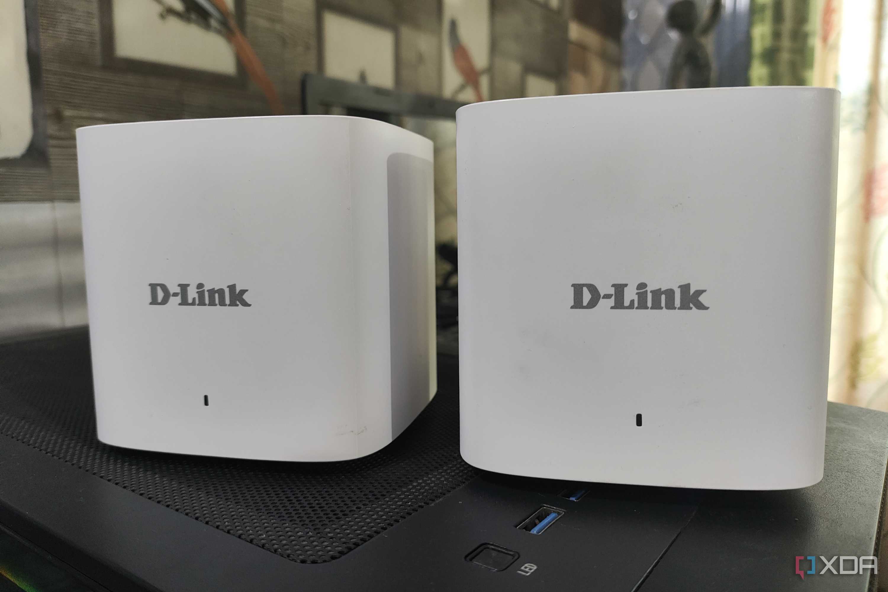Two D-Link M15/2 Eagle Pro AI Mesh routers placed side-by-side
