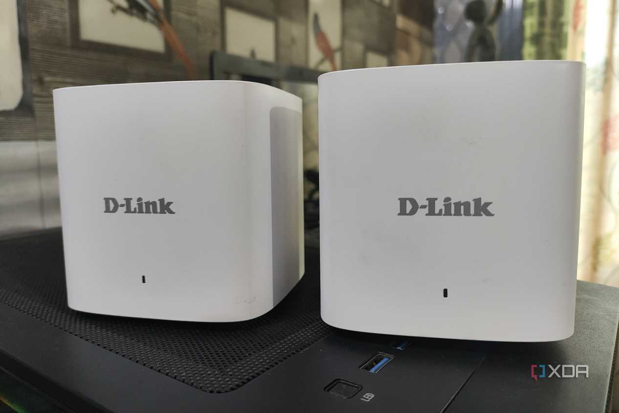 Two D-Link M15/2 Eagle Pro AI Mesh routers placed side-by-side