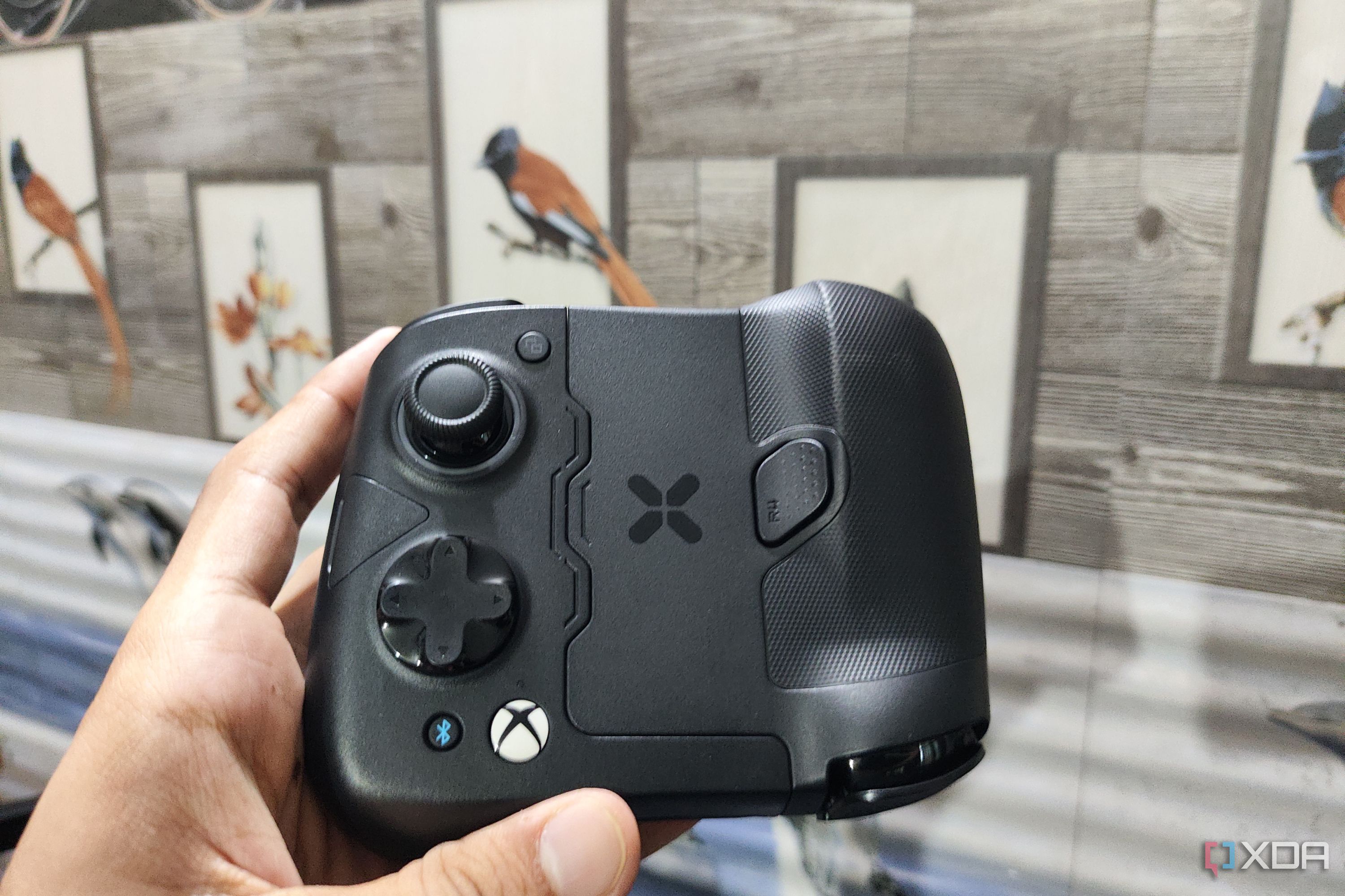 A person holding the GameSir X4 Aileron controller