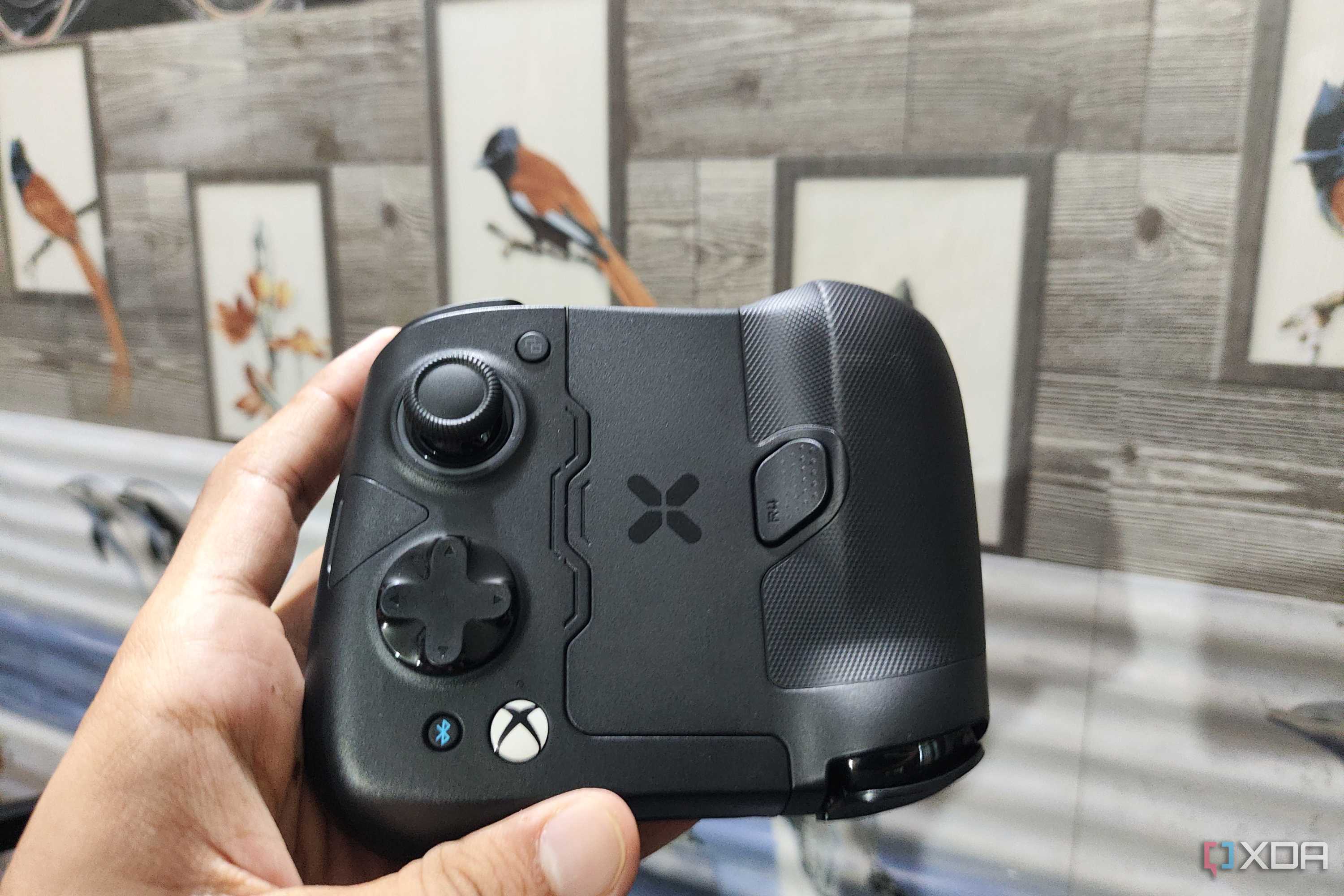 A person holding the GameSir X4 Aileron controller