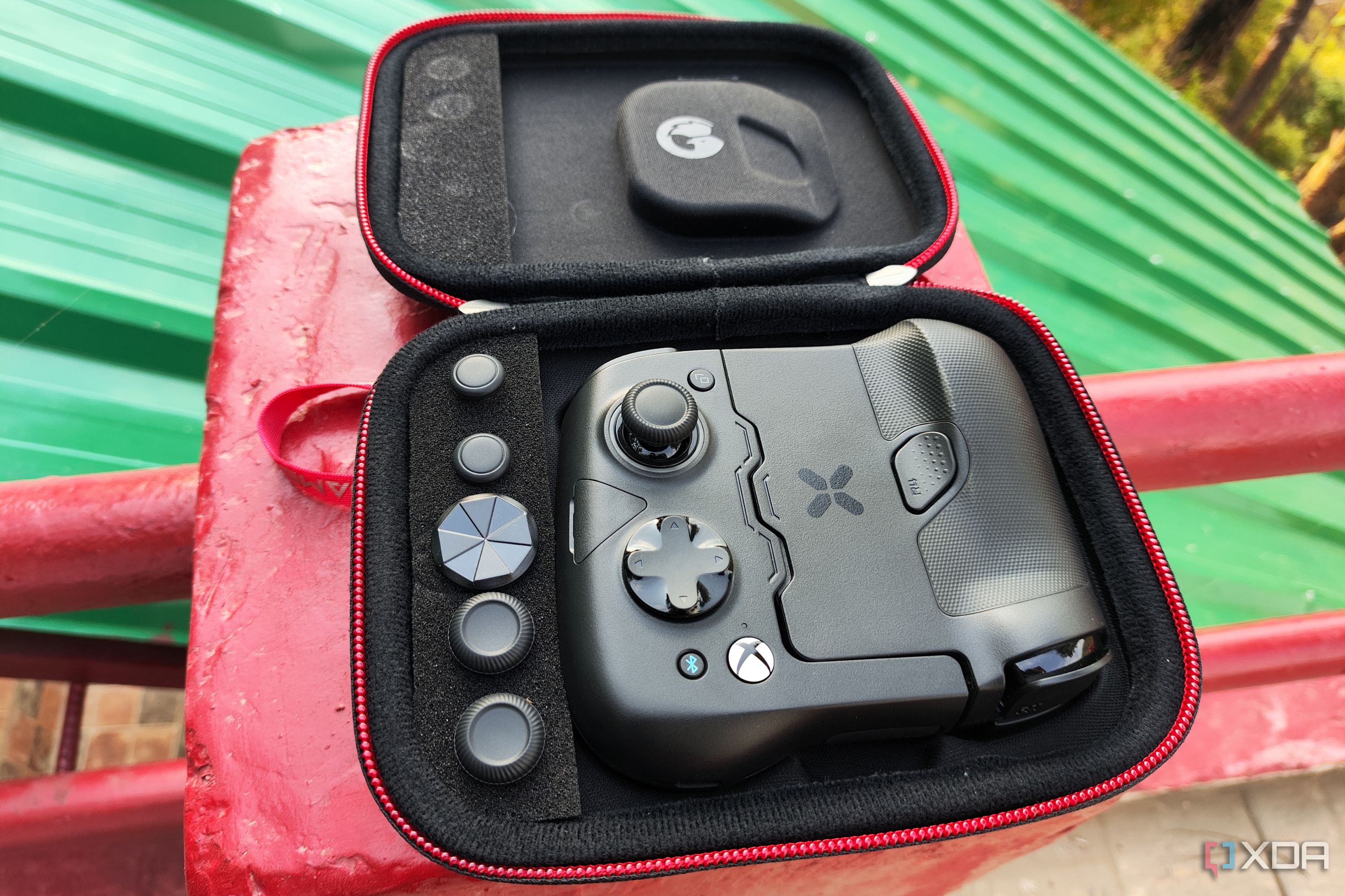 An image of the GameSir X4 Aileron case, with the controller and spare buttons neatly arranged