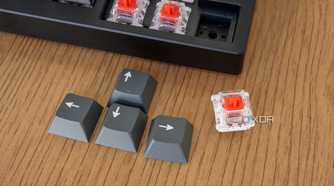 Close-up of the keycaps for the arrow keys on the Lemokey P1 Pro with one removed switch next to it
