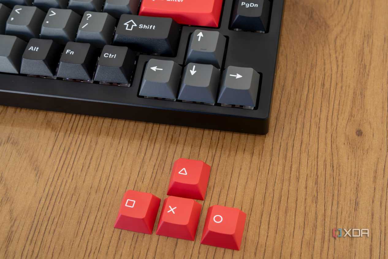 Close-up of the arrow keys next to replacement keycaps included with the Lemokey P1 Pro