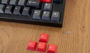 Close-up of the arrow keys next to replacement keycaps included with the Lemokey P1 Pro