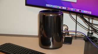 A "trash can" Mac Pro on a desk.