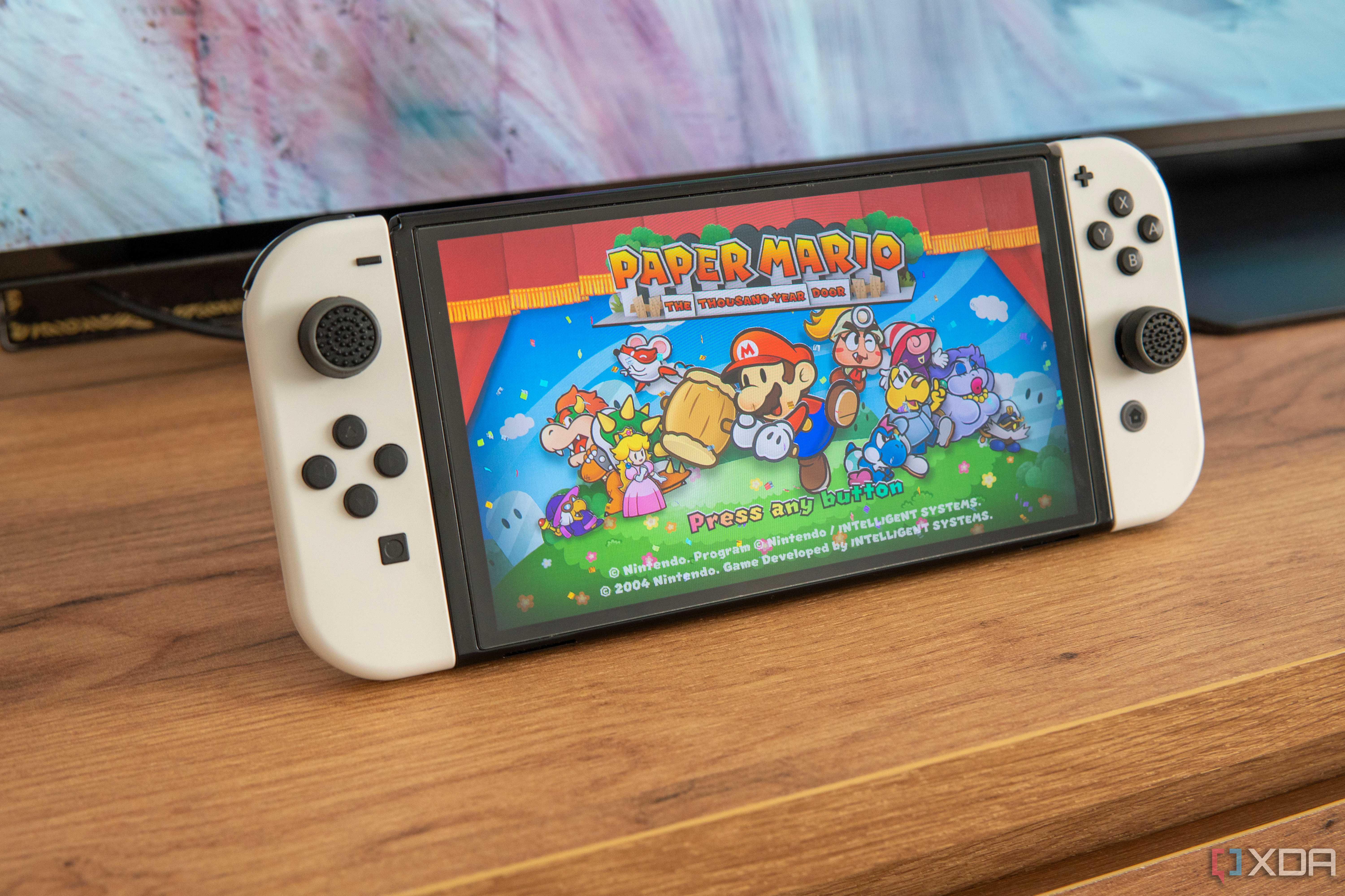Angled view of a Nintendo Switch showing the title screen for Paper Mario The Thousand year Door
