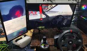 Assetto Corsa running in VR mode, with a Nitho Pro Driving Wheel and Meta Quest 2 lying next to the monitors