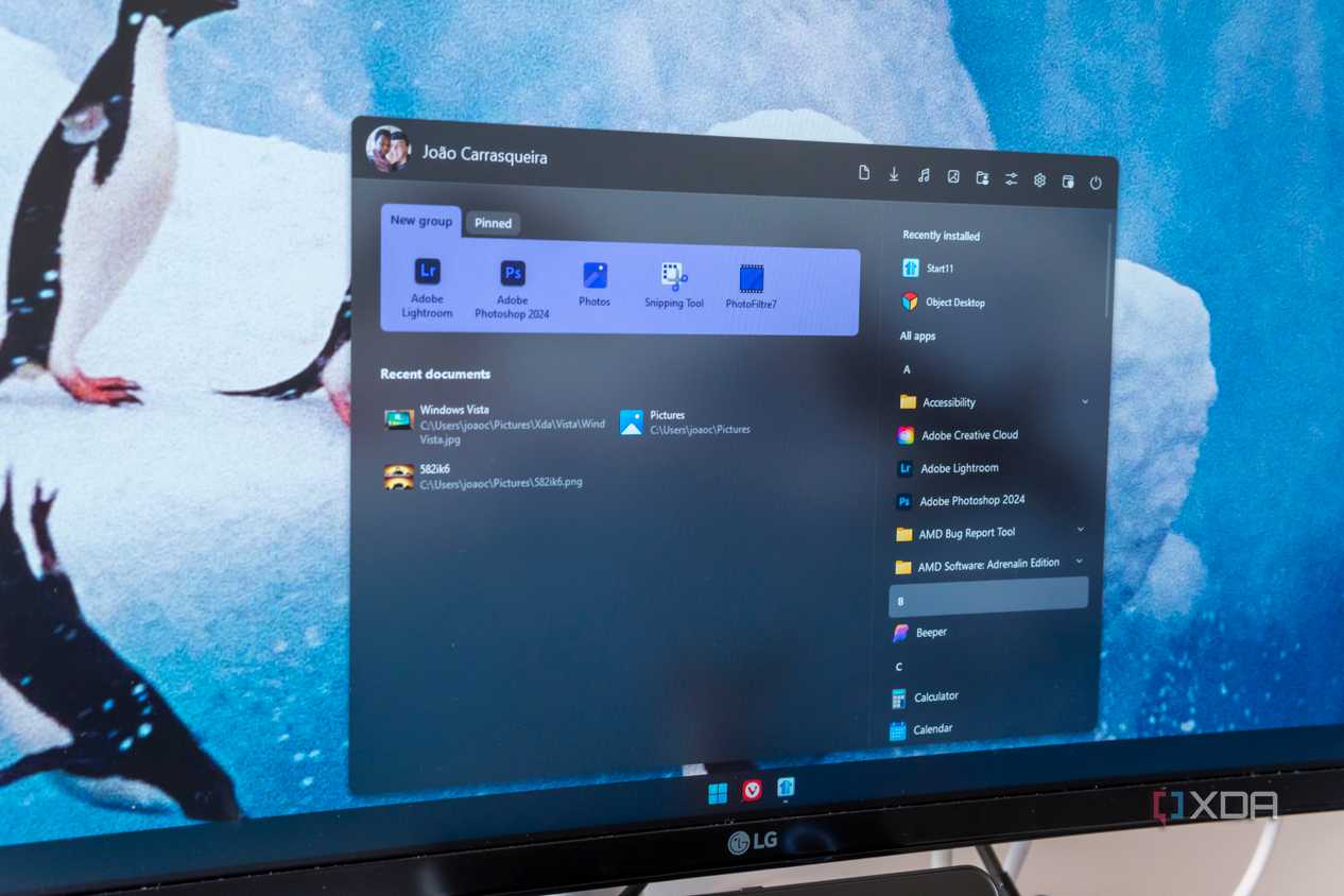 Close-up of a computer monitor displaying a Start11 Start menu on Windows 11