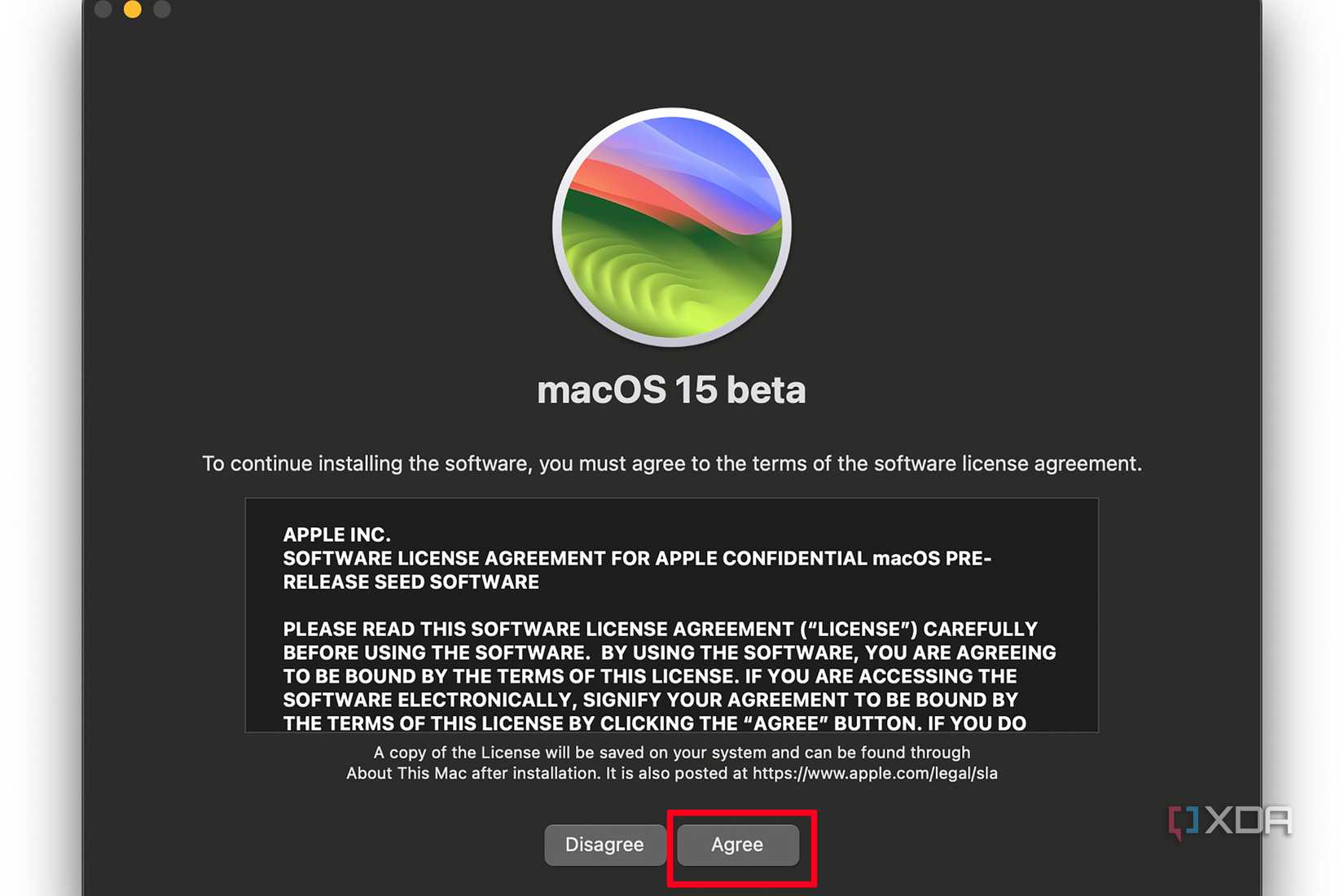 macOS 15 beta installation on a Mac showing the terms of the software license agreement and Agree selected.