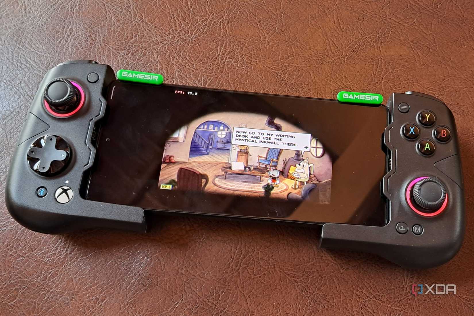 A GameSir X4 Aileron controller connected to a Poco F5, with the phone running Cuphead via Winlator