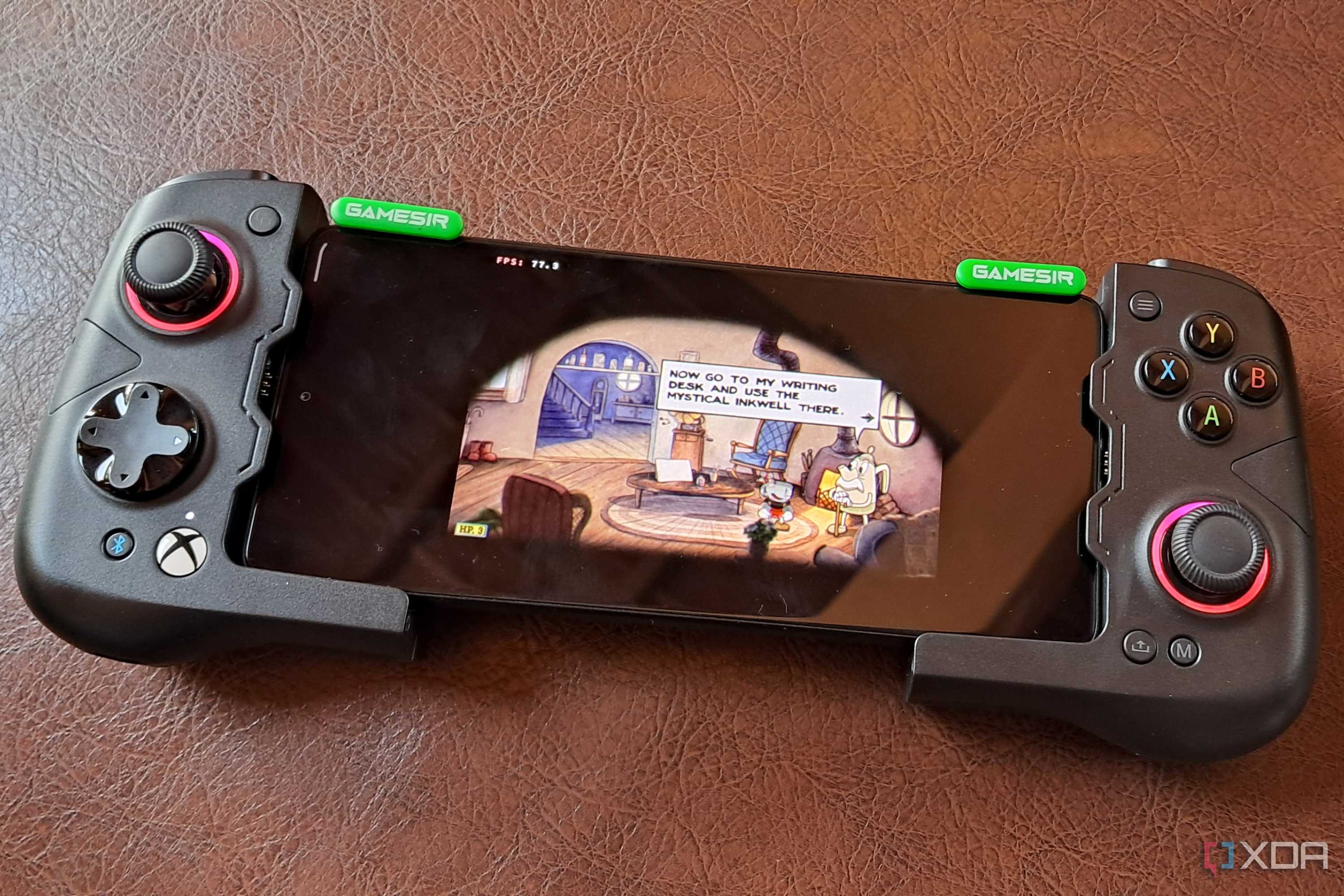 A GameSir X4 Aileron controller connected to a Poco F5, with the phone running Cuphead via Winlator