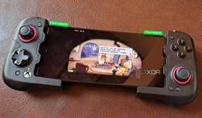 A GameSir X4 Aileron controller connected to a Poco F5, with the phone running Cuphead via Winlator