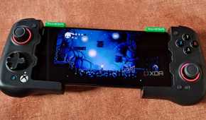 A GameSir X4 Aileron controller connected to a Poco F5, with the phone running Hollow Knight via Winlator