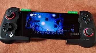 A GameSir X4 Aileron controller connected to a Poco F5, with the phone running Hollow Knight via Winlator