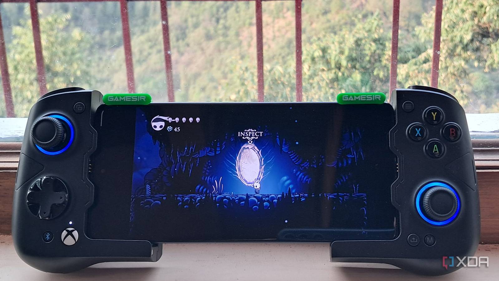 A GameSir X4 Aileron controller connected to a Poco F5, with the phone running Hollow Knight via Winlator