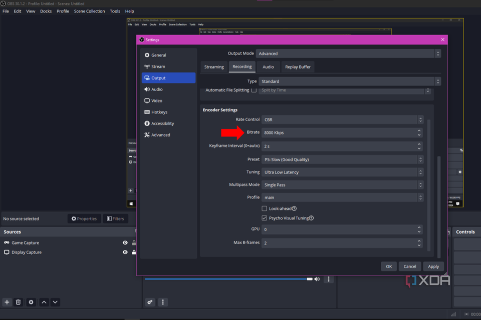 An arrow pointing to the Bitrate setting in OBS Studio