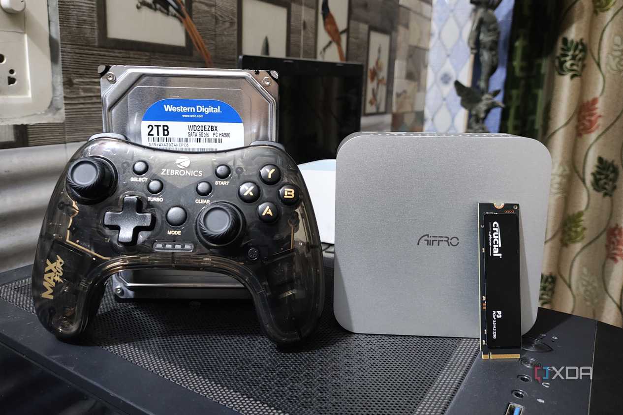 An Aiffro K100 NAS with a controller, an HDD, and an SSD kept nearby