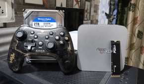 An Aiffro K100 NAS with a controller, an HDD, and an SSD kept nearby
