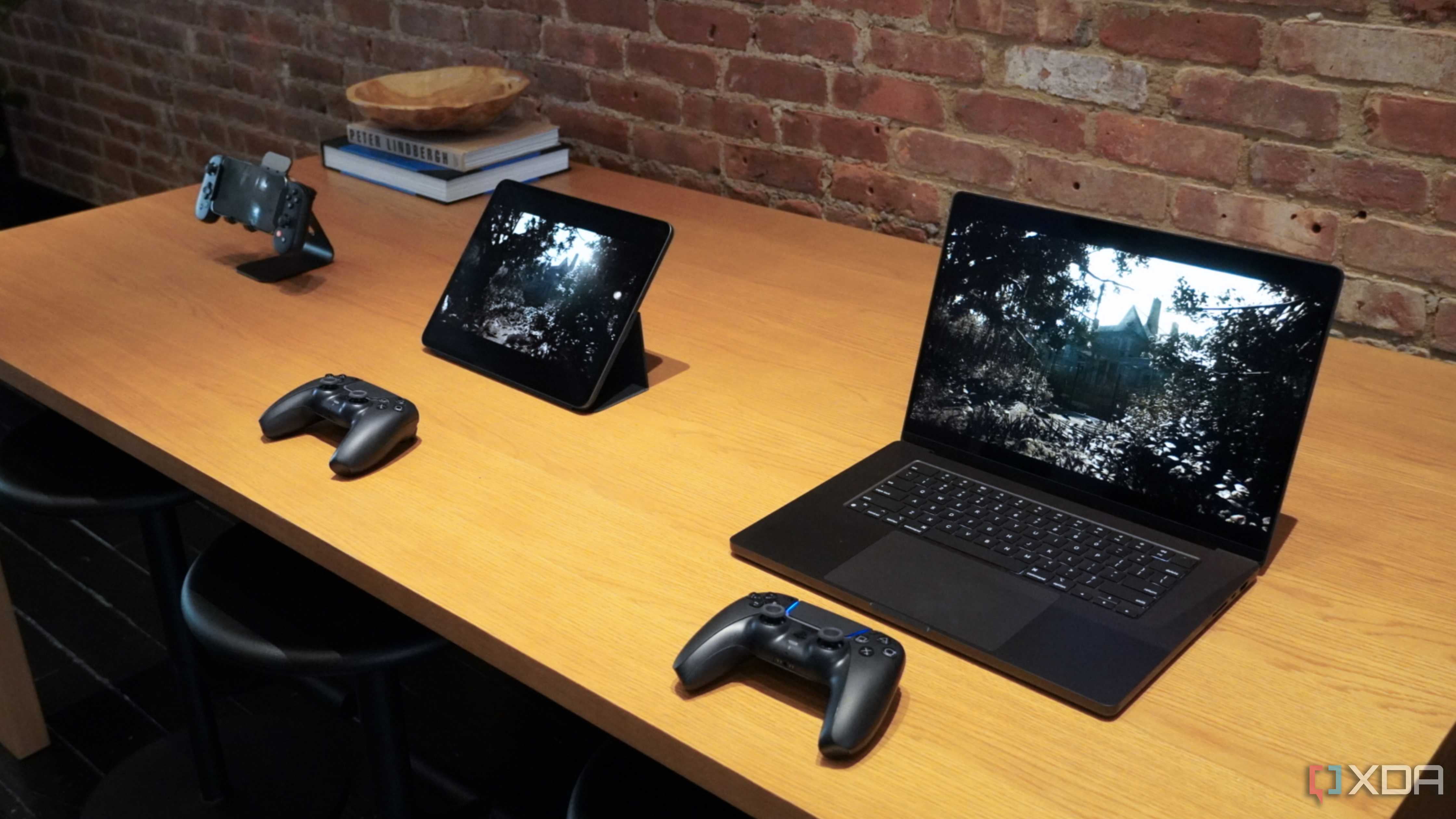 An iPhone, iPad, and MacBook playing the same game on a table.
