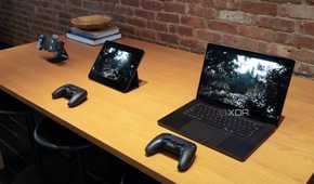 An iPhone, iPad, and MacBook playing the same game on a table.