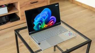 Angled view of the Asus Vivobook S 15 on a glass table