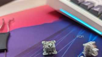 Close-up of a grey-colored mechanical switch next to a keyboard