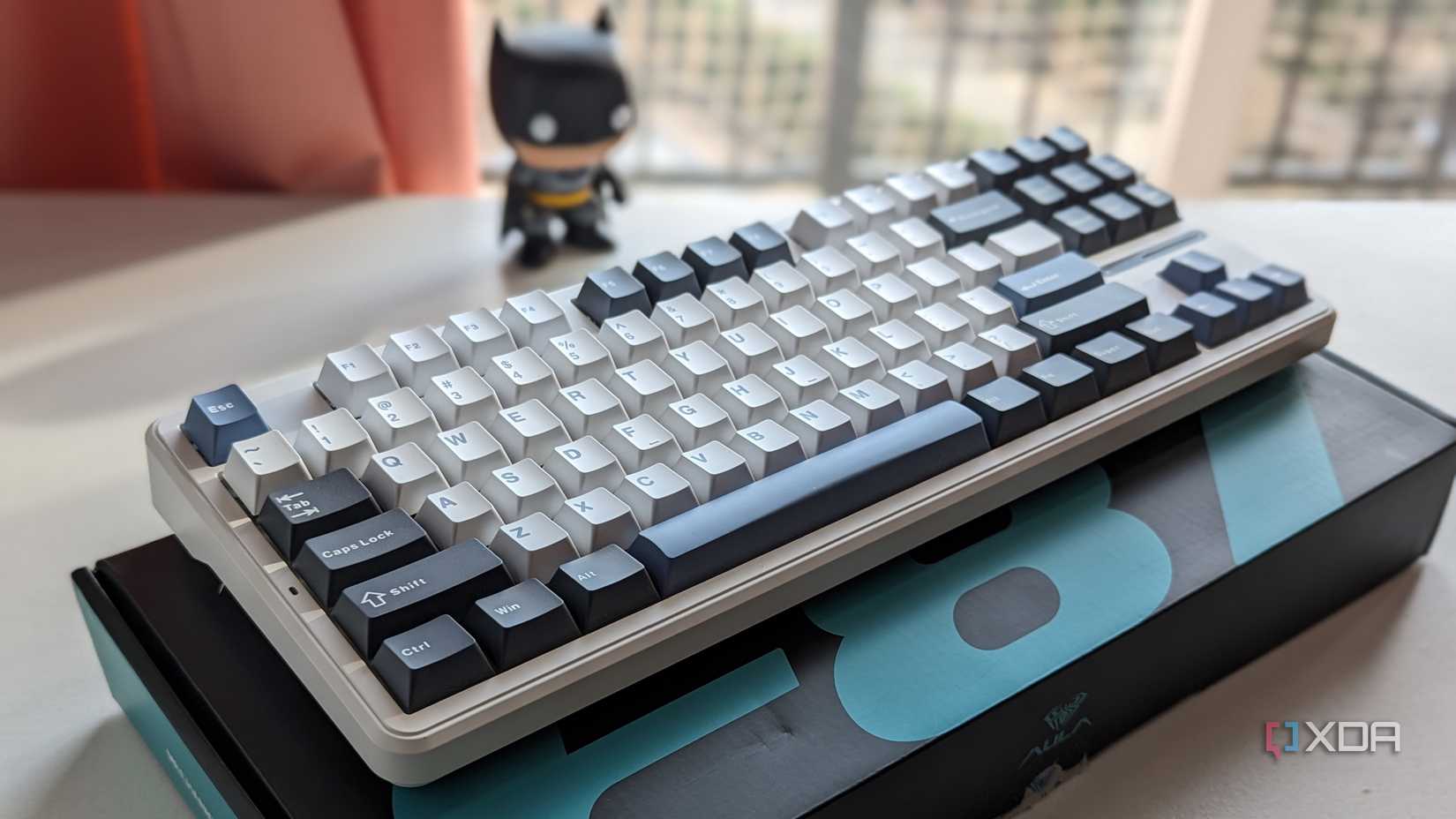 A white themed keyboard is placed on the box