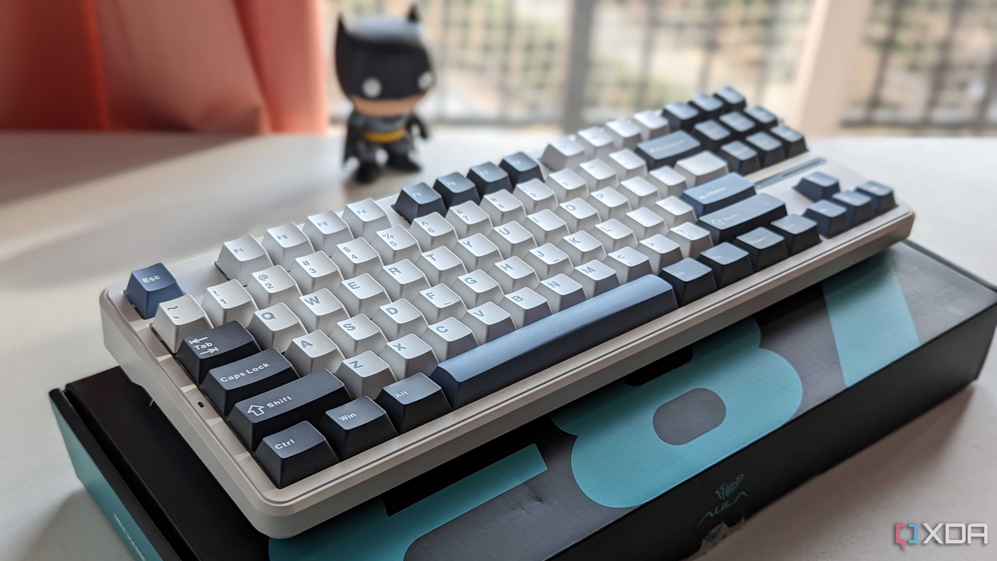A white-themed keyboard placed on its box