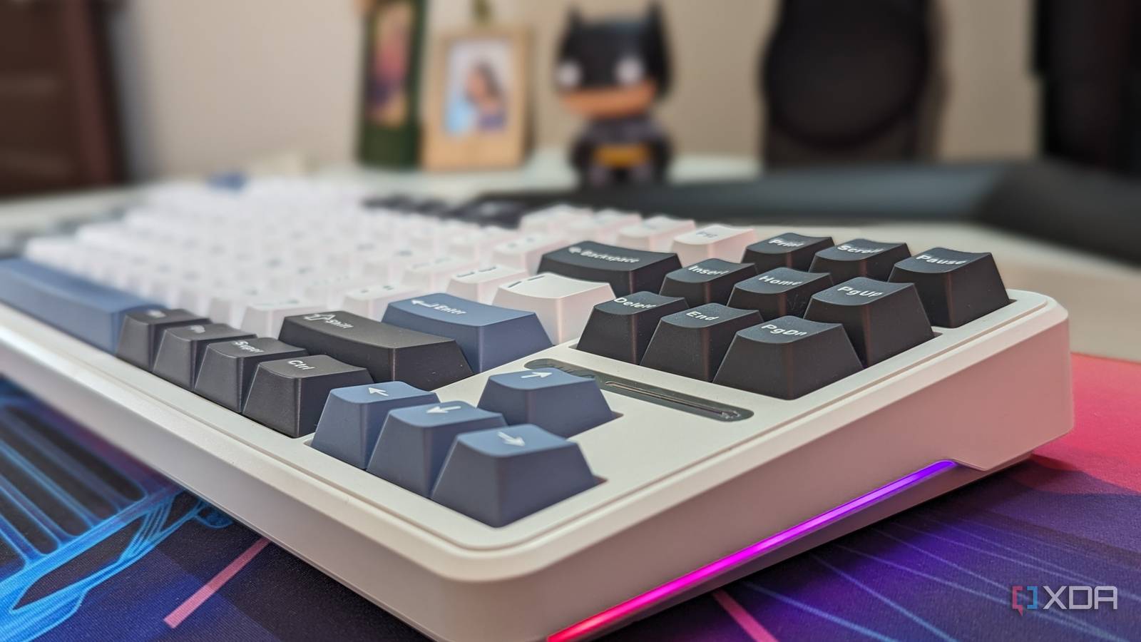 A keyboard shown from a side angle with RGB lighting on