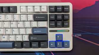 A keyboard shown from the top with RGB lighting on the arrow keys