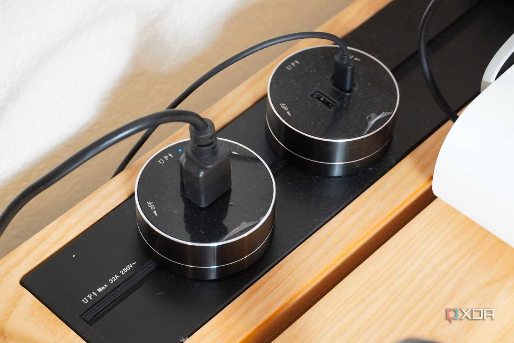 Plugs on the power track system on the SmartDesk Levitate.