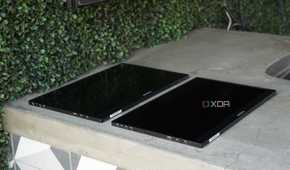 Two Arzopa portable monitors lying flat on a concrete countertop.