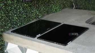 Two Arzopa portable monitors lying flat on a concrete countertop.