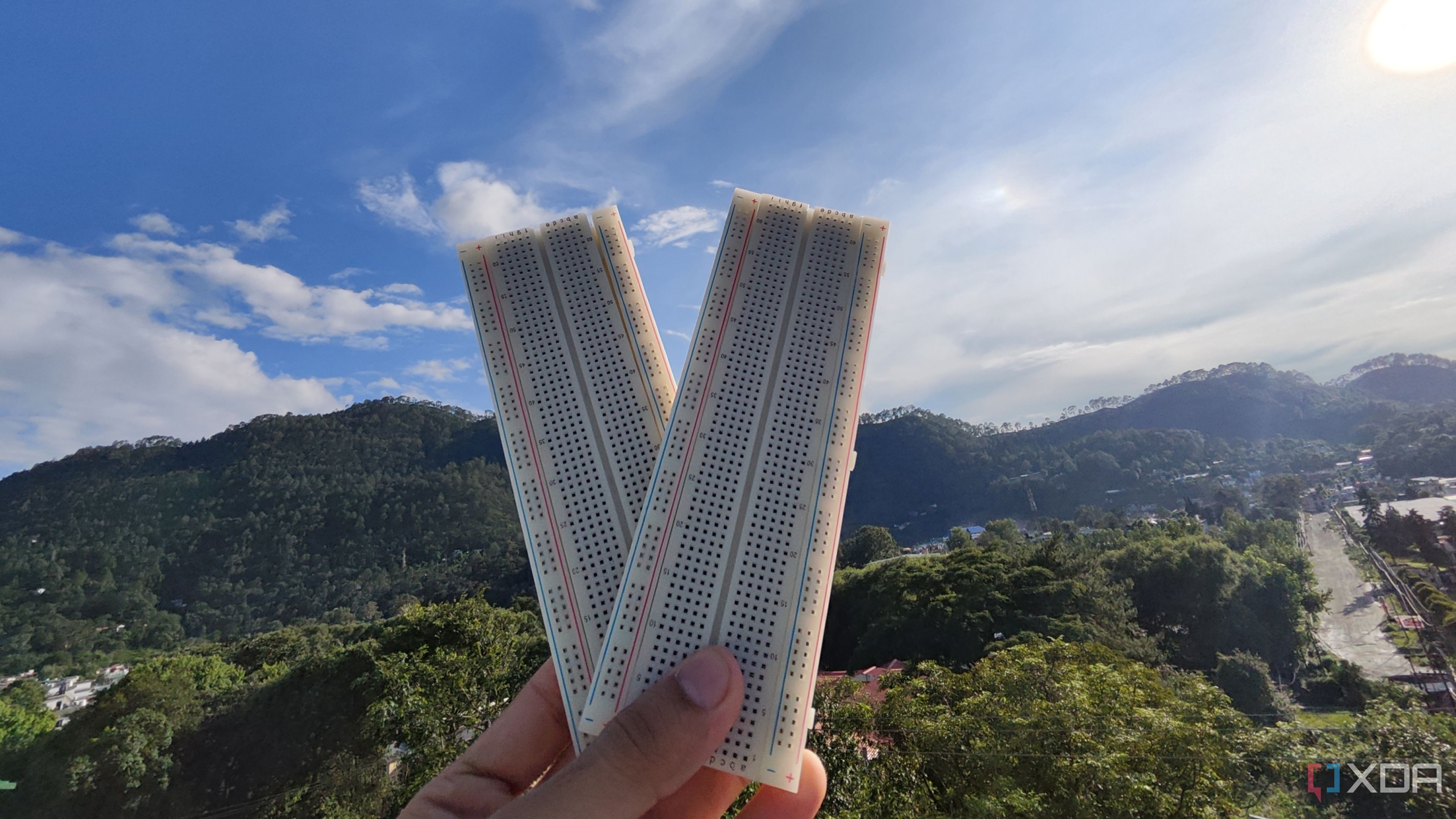 A person holding two breadboards