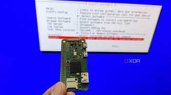 A person holding a Raspberry Pi Zero in front of the DietPi installation wizard