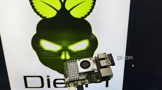 A person holding a Raspberry Pi 5 in front of a monitor displaying the DietPi LXDE desktop environment