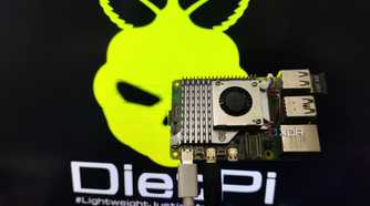 A person holding a Raspberry Pi 5 in front of a monitor displaying the DietPi LXDE desktop environment