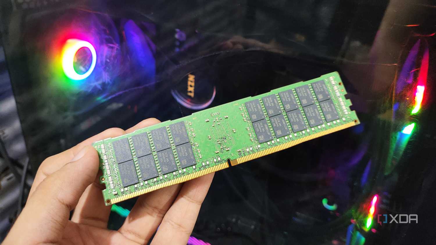 A person holding a 32GB ECC DDR4 RAM stick