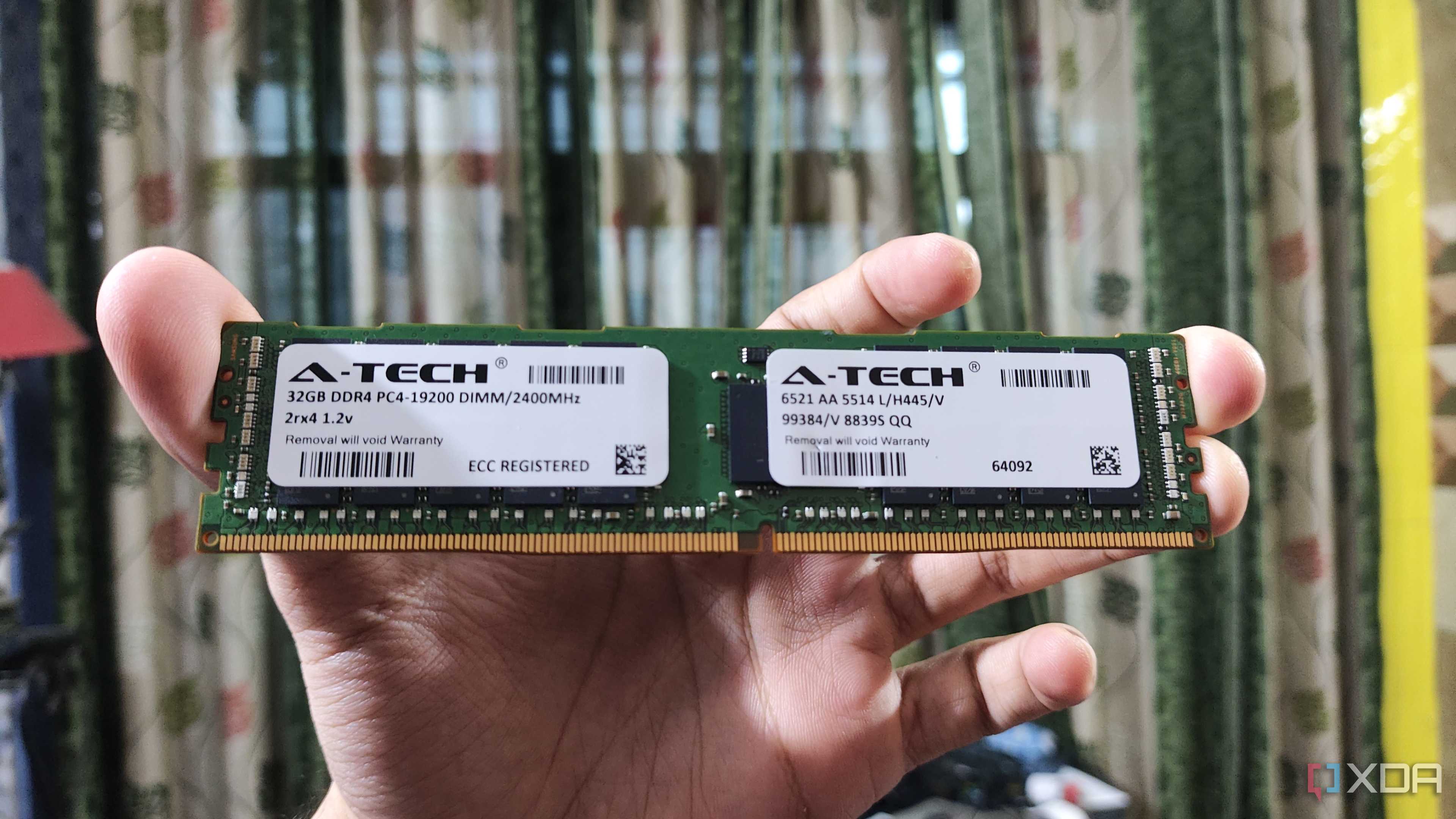 A person holding a 32GB ECC DDR4 RAM stick