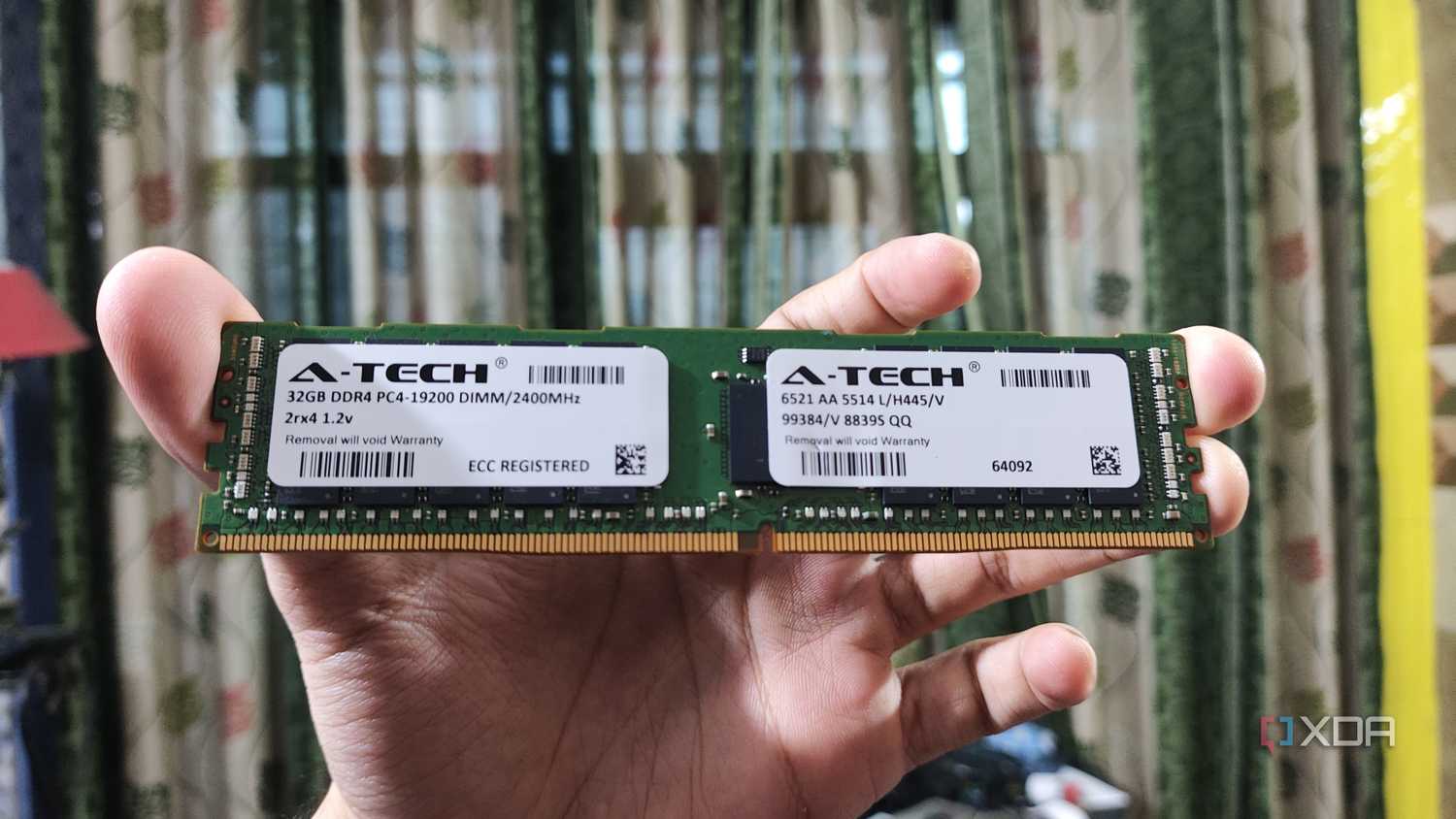 A person holding a 32GB ECC DDR4 RAM stick