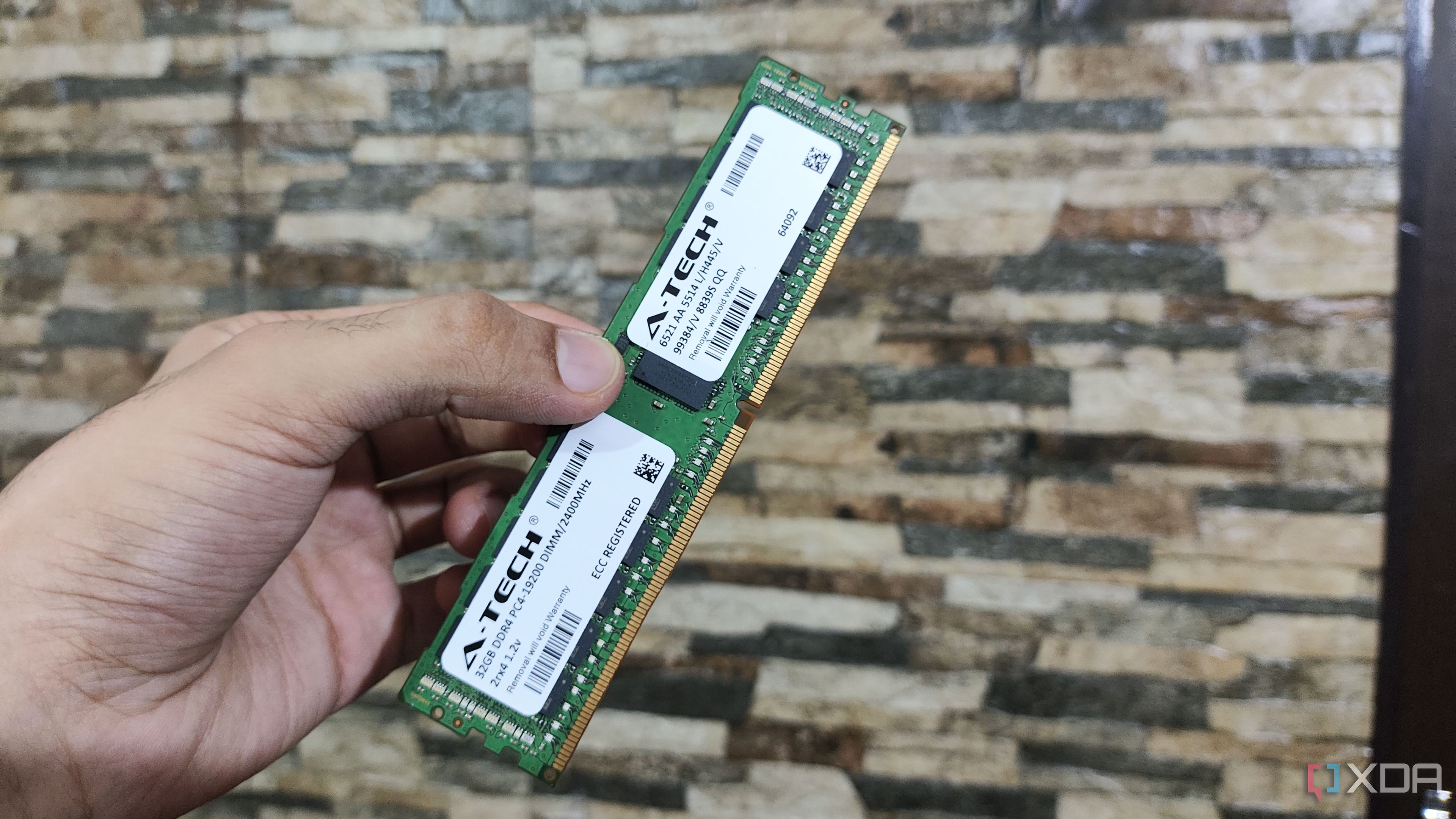 A person holding a 32GB ECC DDR4 RAM stick